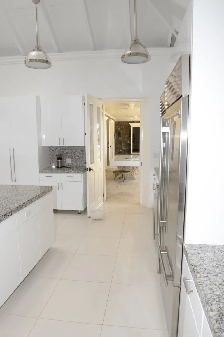 Bright kitchen with clear, freshly wiped countertops after a visit